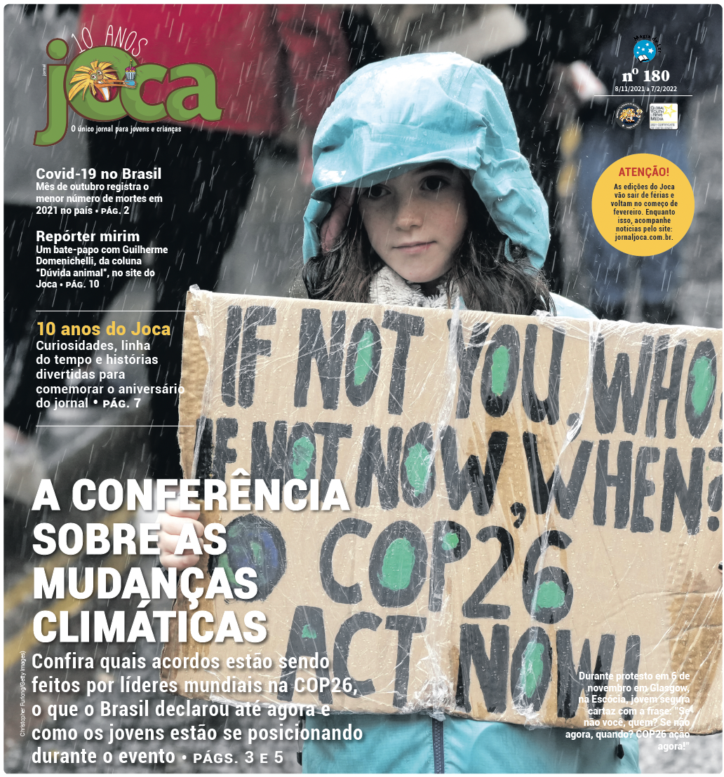 Capa do jornal Joca com criança branca com capa verde segurando cartaz de protesto sobre Clima numa rua com pessoas ao fundo