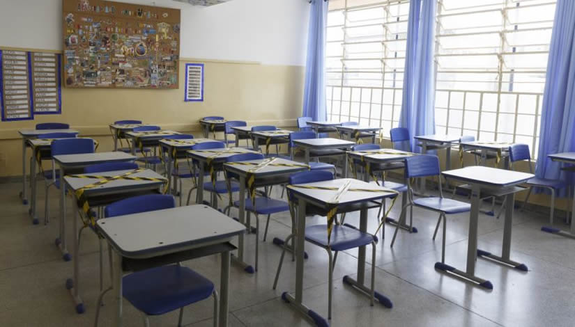 Sala de aula vazia com carteiras enfileiradas