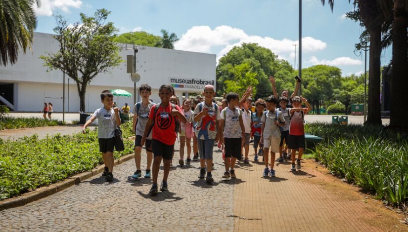 Fotografia mostra grupo de crianças caminhando.